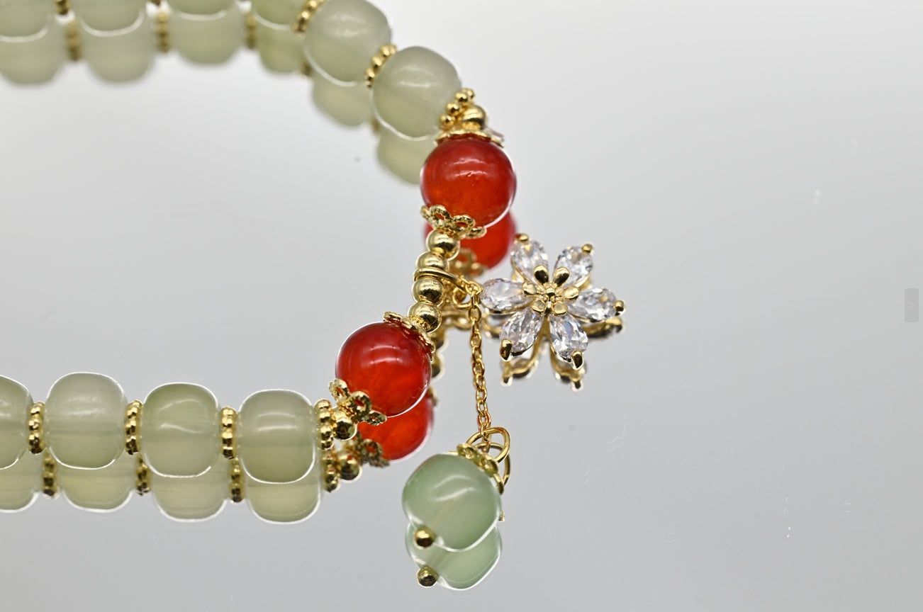 Green and Red Beaded Bracelet with Floral Charm
